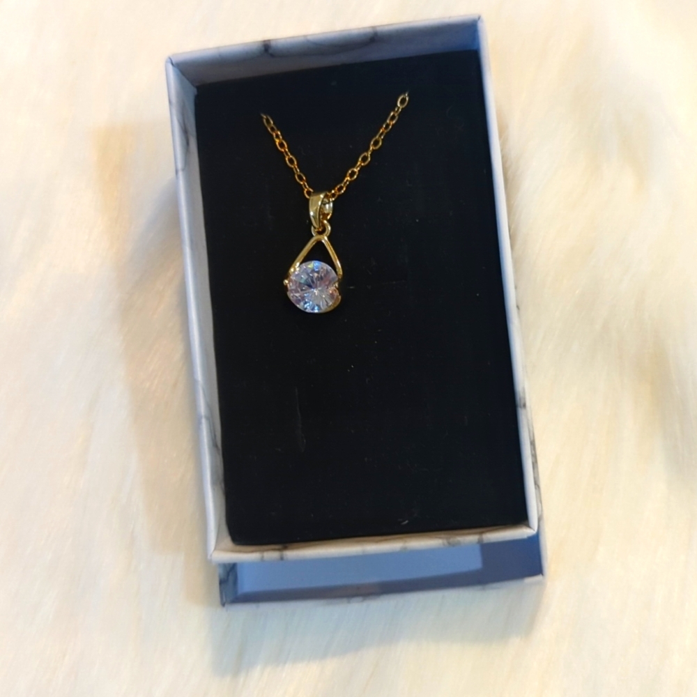 Gold tone necklace with single moissionite stone
